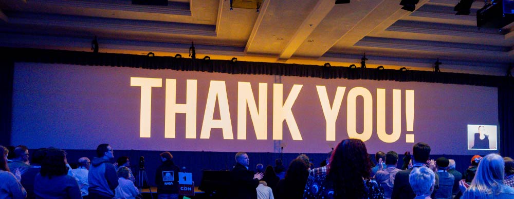 Screen showing the words 'thank you' onstage at the BC NDP Convention