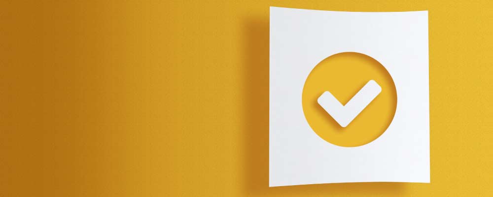 A photo of a white checkmark on a yellow gradient background