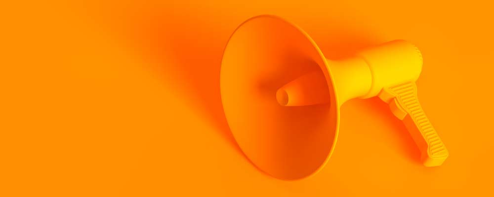 A photo of an orange megaphone on an orange background