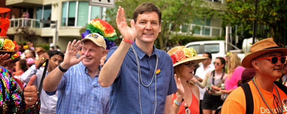 Premier David Eby waves to the crowd from the Vancouver Pride Parade